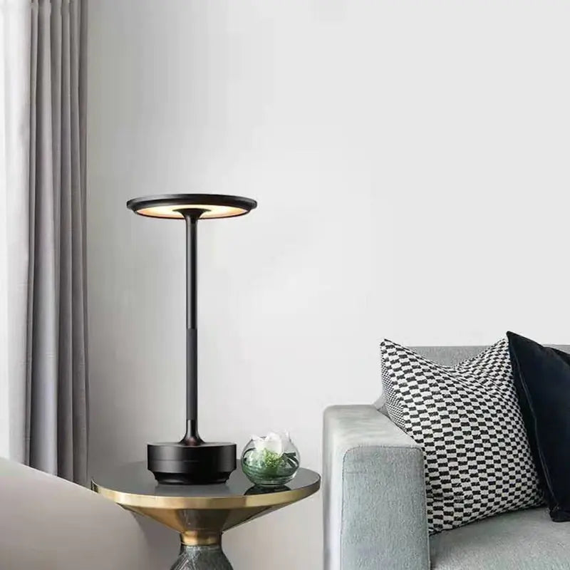 The SP Tower lamp on a round cocktail table in a living room scene