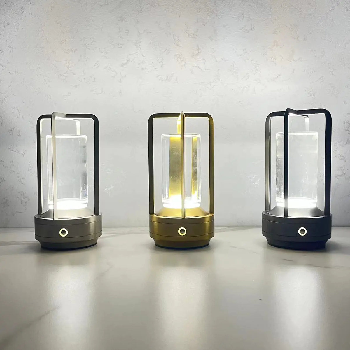 The three Cage style rechargable lamps in gold, silver and black